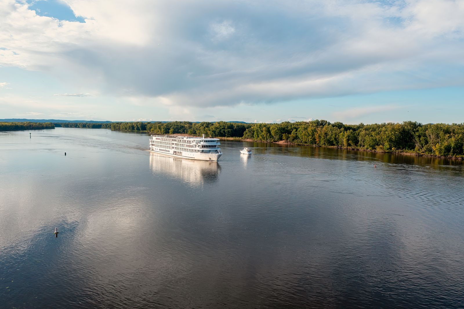 River cruise ship on the calm Upper Mississippi near Wabasha, Minnesota, under a big summer sky